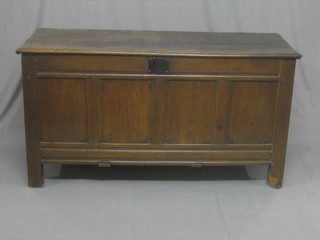 An 18th Century oak coffer of panelled construction with hinged lid, (split to top, requires some attention) 56"