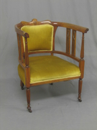 An Edwardian mahogany tub back chair raised on turned and reeded supports