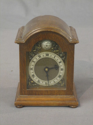 A miniature reproduction Georgian bracket clock with silvered dial and Roman numerals by Davall contained in an arch shaped mahogany case 5"