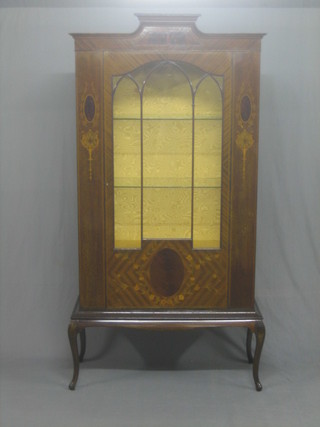 An Edwardian inlaid mahogany bookcase, the interior fitted glass shelves and enclosed by glazed panelled doors, raised on cabriole supports 38"