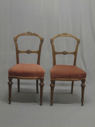 A set of 6 Victorian carved walnut balloon back chairs with shaped mid rails and upholstered seats