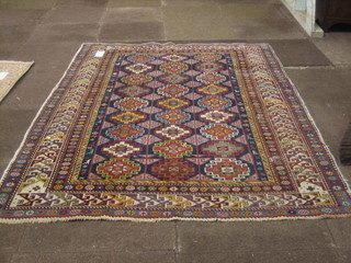 A Caucasian rug with stylised octagons to the centre within multi-row borders 69" x 52"