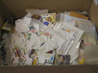 A cardboard box containing a collection of various album pages, loose stamps etc
