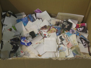 A cardboard box containing a collection of various stamps