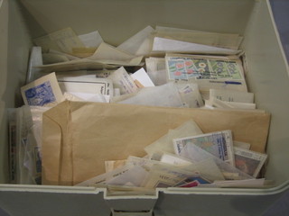 A plastic box containing a collection of various stamps