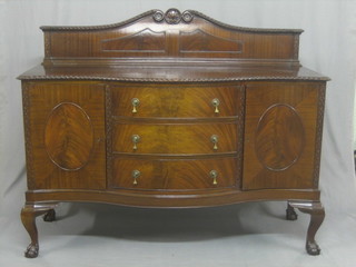An Edwardian Chippendale style mahogany sideboard of serpentine outline, with raised back, fitted 3 drawers flanked by a pair of cupboards, raised on cabriole ball and claw supports 60"