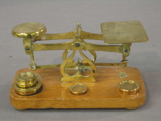 A pair of oak and brass letter scales