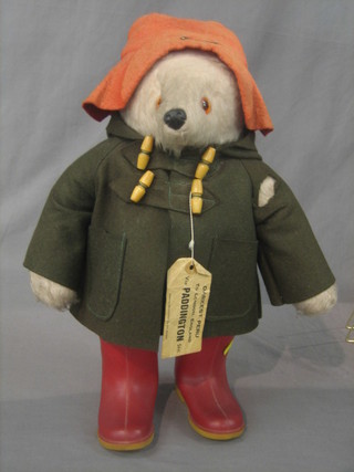 A model of Paddington Bear with green duffel coat and label