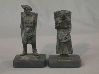 A pair of 19th Century bronze spill vases in the form of a lady and gentleman grape picker with panniers 7"