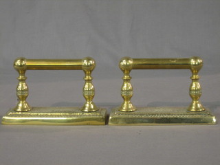 A pair of 19th Century brass fire dogs