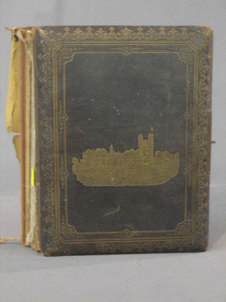 A leather bound photograph album with musical box movement