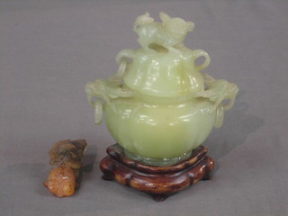 A carved jade coloured twin handled urn and cover 4 1/2" together with a hardstone figure of a carp 2 1/2"