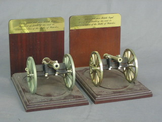 A pair of wooden and metal bookends in the form of 6 pound field pieces used at Waterloo