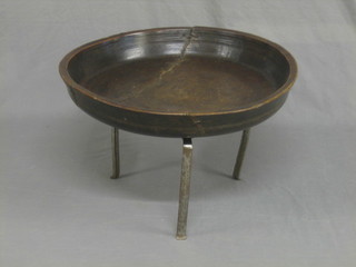 A circular turned wooden dish with metal banding (dish with old split), raised on a metal stand 26"