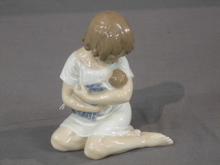 A Royal Copenhagen figure of a kneeling girl with doll, base marked 1938 5"
