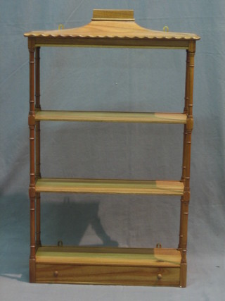 A Regency style bleached mahogany 3 tier hanging what not, the base fitted a drawer 22"