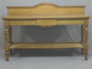 A Victorian bleached mahogany 2 tier serving table, with raised back by Maple & Co, raised on turned and block supports 72"