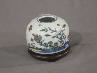 A circular Oriental vase decorated butterflies in branches, the base with seal mark 2"