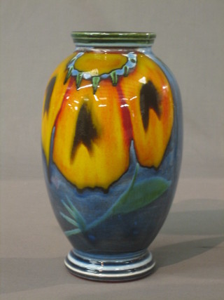 A circular Poole Pottery blue and orange glazed vase the base marked Poole England 10"