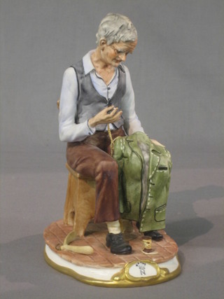 A Capo di Monte figure of a seated tailor 9"