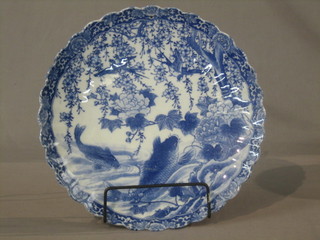 An Oriental blue porcelain bowl decorated a diving carp, with lobed body 12"