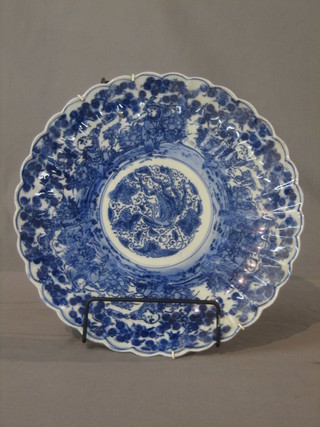 A circular Oriental plate with lobed border and blue and white decoration 12"