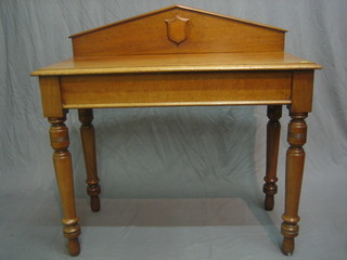 A Victorian bleached mahogany hall table with raised back, raised on turned supports 39"