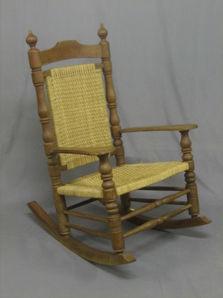An Eastern hardwood rocking chair with woven cane seat and back