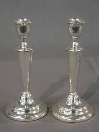 A pair of modern silver candle sticks, London, 7"
