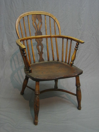 A 19th Century elm stick back Windsor chair with pierced slat back and cow horn stretcher, raised on turned supports