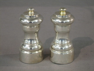A silver salt and pepper mill of waisted form, London 1979 4"