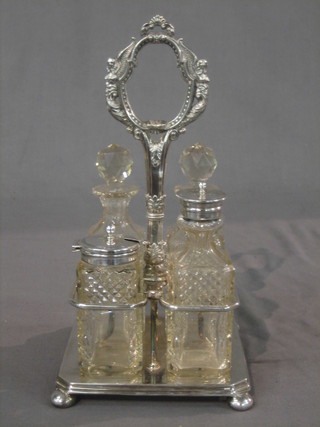 A Victorian silver plated 4 bottle cruet frame with 4 cut glass bottles, raised on bun feet