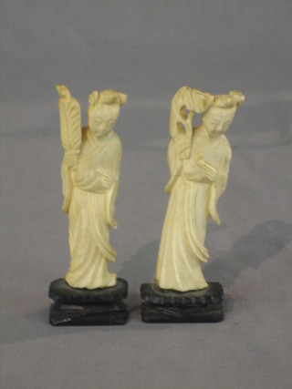 A pair of carved ivory figures in the form of standing courtiers 4"