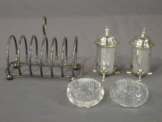 A silver plated 7 bar toast racket, 2 plated pepperettes and 2 circular glass salts