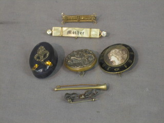A 19th Century oval gilt metal and black enamelled mourning brooch, a gilt brooch, a brooch in the form of a hunting horn and various other brooches