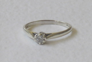A white gold dress ring set a solitaire diamond