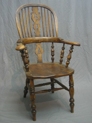 An 18th/19th Century elm Windsor stick back carver chair raised on turned supports