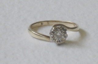 A lady's gold dress ring set a solitaire diamond