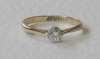 An 18ct yellow gold dress ring set a solitaire diamond