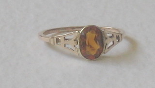 A lady's yellow gold dress ring set an oval cut amber coloured stone