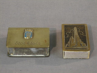 A 1930's American match gilt metal match slip marked Rockefeller Centre New York City New York and 1 other marked Stockholm