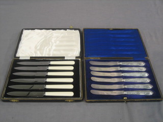 A set of 6 silver handled tea knives, cased and 1 other set of tea knives, cased