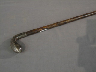 A bamboo finished walking stick with silver handle