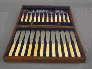 A set of 12 silver plated fish knives and forks contained in a walnut canteen box