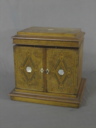 A Victorian inlaid walnut vanity box with hinged lid, the interior fitted 3 long drawers enclosed by panelled doors, inlaid throughout (split to top) 12"