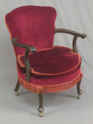 A beech framed open armchair upholstered in red material