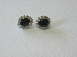 A pair of sapphire and cubic zirconia set ear studs