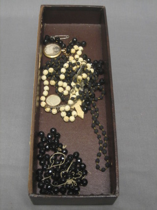 An ivory rosary hung a cross with Stanhope, 2 gilt metal lockets and a string of "jade" beads