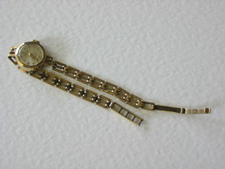 A lady's gold wristwatch by Avia contained in a 9ct gold and with 9ct gold integral bracelet