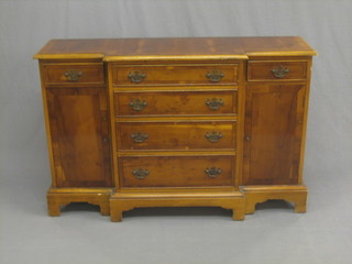 A Georgian style yew wood breakfront cabinet, fitted 4 long drawers flanked by  a pair of cupboards raised on bracket feet 45"
